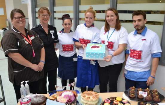 People in British Liver Trust t-shirts raise money at a cake stall