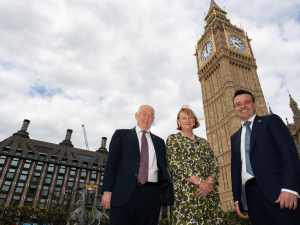 Pamela Healy OBE, Chief Executive of British Liver Trust stands in front of the Westminster Parliament with Wayne David MP (Chair) and Stephen McPartland MP (Co-Chair) of the All Party Parliamentary Group on Liver Disease and Liver Cancer