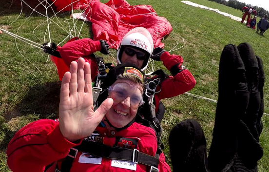 Skydivers high five after landing